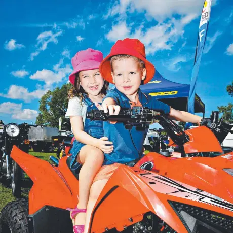  ?? Picture: MICHAEL FRANCHI ?? Cameron Murray and sister Eliza Murray check out a kids quad bike at the 4WD, Boating & Camping Expo