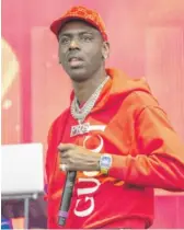  ?? SUZANNE CORDEIRO/AFP VIA GETTY IMAGES ?? Young Dolph, who was born in Chicago, performs in 2019.