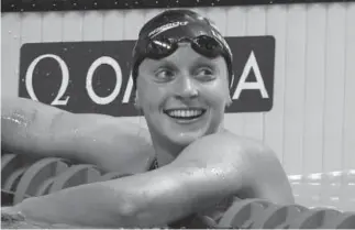  ??  ?? Katie Ledecky likes the time she sees on the scoreboard after winning the gold medal in the 1,500-meter freestyle at the 2017 world championsh­ips.