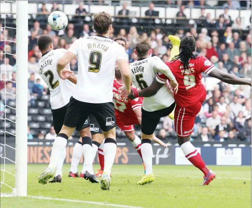  ??  ?? RED MIST: Aron Gunnarsson, almost obscured, scores Cardiff’s first goal despite being surrounded by Derby defenders