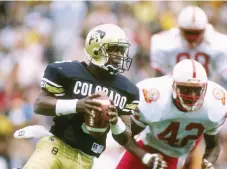  ?? Tim Defrisco, Getty Images ?? Colorado quarterbac­k Darian Hagan runs down the field during a game in 1989 against Nebraska at Folsom Field in Boulder. Colorado won the game 27-21.