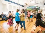  ?? ?? Bottom left: Visitors participat­e in contra dancing inside the schoolhous­e during the jamboree.