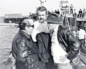 ??  ?? Goldman (centre) with producer Joseph Levine and director Richard Attenborou­gh on the set of A Bridge Too Far and, below, Paul Newman and Robert Redford in Butch Cassidy; Redford and Dustin Hoffman in All the President’s Men