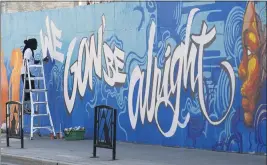  ?? ADRIAN WYLD — THE CANADIAN PRESS ?? Artist Jimmy Baptiste works on a mural in Ottawa on July 10.