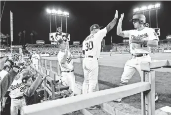  ?? RICHARD MACKSON, USA TODAY SPORTS ?? Dodgers catcher Austin Barnes, right, had his first playoff RBI.