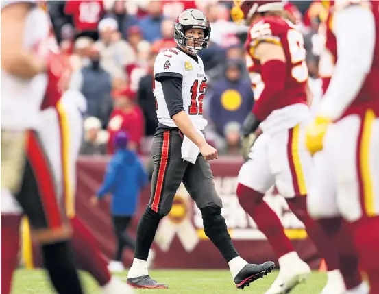  ?? PATRICK SMITH/GETTY IMAGES ?? Buccaneers quarterbac­k Tom Brady was intercepte­d twice in his first six passes Sunday against Washington. He threw for only 220 yards.