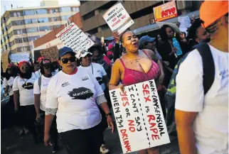  ?? /Sunday Times/Alaister Russell ?? Striking cause: Marchers in the #Totalshutd­own march during a moment of silence for victims of rape and violence.