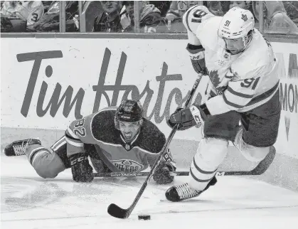  ?? PERRY NELSON • USA TODAY SPORTS ?? Toronto Maple Leafs' John Tavares moves the puck in front of Edmonton Oilers' Caleb Jones during NHL action on Saturday in Edmonton.