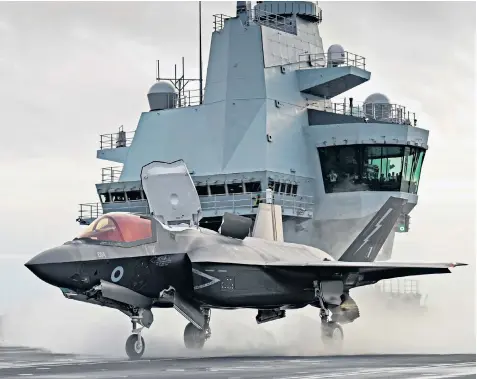  ??  ?? An F-35B Lightning jet on the flight deck of HMS Queen Elizabeth. The RAF has been accused of pushing to buy a variant of the fighter that cannot take off from the aircraft carrier