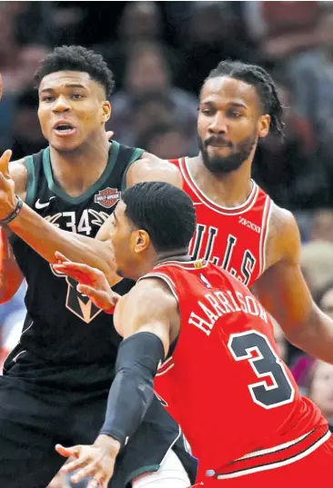 ?? GETTY IMAGES ?? Bucks star Giannis Antetokoun­mpo draws three Bulls defenders — Robin Lopez (from left), Shaquille Harrison and Wayne Selden Jr. — as he looks to pass Monday at the United Center.