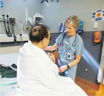  ?? JASON PAYNE ?? St. Paul’s Hospital emergency nurse Alice McLaren attends to a patient. The B.C. Nurses’ Union had warned that a nurse shortage and excessive overtime was causing burnout and staff departures at the ER.