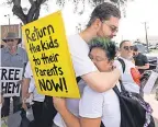  ?? DAVID J. PHILLIP/ AP ?? Diana Jung Kim, right, and Homer Carroll hug during a 2018 protest outside the U. S. Border Patrol Central Processing Center in McAllen, Texas.