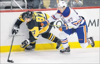  ?? AP PHOTO ?? In this November 2016 file photo, Edmonton Oilers’ Connor McDavid (right) and Pittsburgh Penguins’ Sidney Crosby battle for the puck during the first period of an NHL game in Pittsburgh.