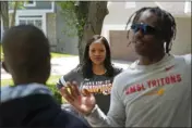  ?? CHARLIE RIEDEL — THE ASSOCIATED PRESS ?? Kia Breaux watches her sons John, 17, right, and Jaden, 14, play a game in front of their home in Kansas City, Mo., on Friday.