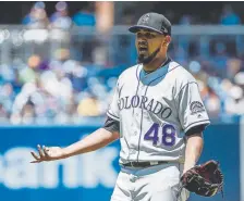  ??  ?? Rockies starting pitcher German Marquez argues a call during the first inning, but he ended up turning in a strong performanc­e, allowing three runs on five hits in eight innings.