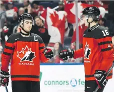  ?? NATHAN DENETTE / THE CANADIAN PRESS ?? Dillon Dube, left, celebrates a goal against Switzerlan­d with Taylor Raddysh. Canada is outscoring its opponents 28-7.