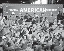  ?? Saul Loeb AFP/Getty Images ?? WORKERS listen as President Trump touts tariffs on foreign steel at a U.S. Steel mill in Granite City, Ill., in July. “Workers are back on the job,” Trump said then.