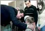  ??  ?? Syria's President Bashar alAssad speaks with children