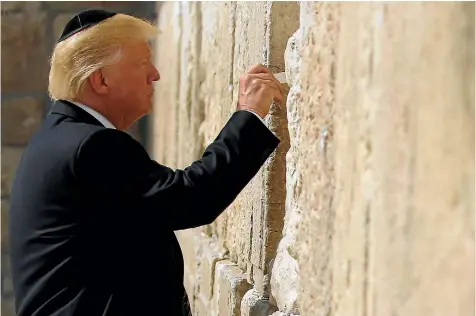  ?? PHOTO: REUTERS ?? US President Donald Trump leaves a note at the Western Wall in Jerusalem.