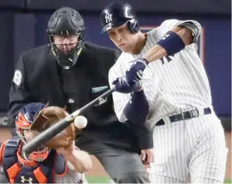  ?? (Photo by Frank Franklin II, AP) ?? New York Yankees’ Aaron Judge hits a three-run home run during the fourth inning of Monday’s game against the Houston Astros.