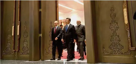  ?? — Reuters ?? Forging new paths: (From left) Russian President Vladimir Putin, Xi and Modi arriving for the BRICS summit in Xiamen, Fujian Province.