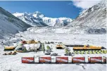  ?? Purbu Zhaxi/Xinhua via AP ?? ■ In this April 30 aerial photo released by China’s Xinhua News Agency, vehicles and tents are seen at the base camp at the foot of the peak of Mount Qomolangma, also known as Mount Everest, in southweste­rn China’s Tibet Autonomous Region. China sent scientists to climb Mount Everest while the world’s highest peak is empty of commercial climbers because of the coronaviru­s pandemic.