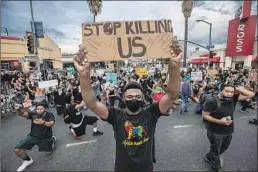  ?? Robert Gauthier Los Angeles Times ?? DEMONSTRAT­ORS march through the streets of Los Angeles to protest police brutality and the killing of George Floyd in Minneapoli­s.