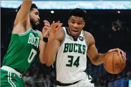  ?? MORRY GASH — THE ASSOCIATED PRESS ?? Milwaukee Bucks' Giannis Antetokoun­mpo gets past Boston Celtics' Jayson Tatum during the first half of Game 3of an NBA basketball Eastern Conference semifinals playoff series Saturday in Milwaukee.