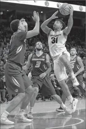  ?? NWA Democrat-Gazette/ANDY SHUPE ?? Arkansas guard Anton Beard (31) drives to the basket as Missouri forward Jontay Porter (left) defends Saturday during the second half at Walton Arena in Fayettevil­le. Beard is set to face his former North Little Rock teammate KeVaughn Allen when the...