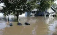  ?? THE ASSOCIATED PRESS ?? The tops of mailboxes barely break the surface of floodwater­s from the Cedar River in the North Cedar neighborho­od of Cedar Falls, Iowa on Saturday.