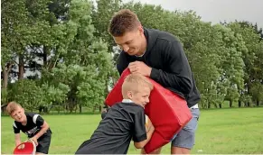  ?? ?? Max Drought, 6, tries his best to crash through Beauden Barrett.