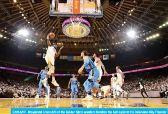  ?? — AFP ?? OAKLAND: Draymond Green #23 of the Golden State Warriors handles the ball against the Oklahoma City Thunder during a game on Tuesday at Oracle Arena in Oakland, California.