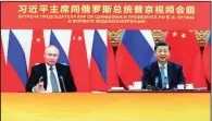  ?? (AP/Xinhua/Yin Bogu) ?? Chinese President Xi Jinping (right) attends a virtual meeting with Russian President Vladimir Putin on Wednesday in Beijing. Video online at arkansason­line.com/1216meet/.