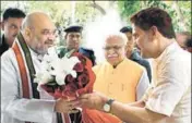  ??  ?? ■ BJP state chief Subhash Barala (right) welcoming party national president Amit Shah as Haryana CM Manohar Lal Khattar looks on, at Haryana Bhawan in New Delhi on Friday. HT PHOTO