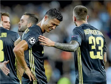  ?? AP ?? Juventus striker Cristiano Ronaldo is consoled by team-mate Federico Bernardesc­hi, right, after receiving a red card during yesterday’s Champions League match against Valencia in Valencia.