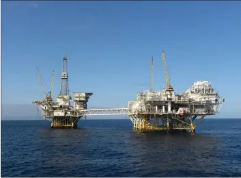  ?? BUREAU OF SAFETY AND ENVIRONMEN­TAL ENFORCEMEN­T ?? The platforms Ellen and Elly stand offshore near Long Beach.