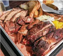  ?? J.C. Reid photos ?? Ray’s BBQ Shack serves East Texas-style pork spareribs, front to back, Lott’s links sausage, rib tips and Central Texas-style brisket.