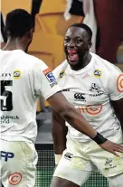  ?? | DARREN ENGLAND EPA ?? MADOSH Tambwe, right, of the Sharks celebrates scoring a try with Aphelele Fassi during the Super Rugby match against the Queensland Reds in Brisbane last year.