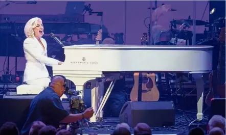  ??  ?? Surprise show: (Above left) Lady Gaga performing at the concert where she pledged US$1mil (RM4.22mil) to the fund. (Above right) Trump’s video-taped message being played during the concert. — AFP/Reuters