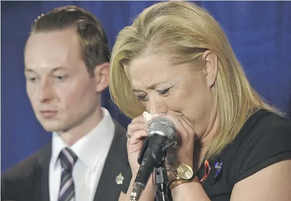  ?? ED KAISER ?? An emotional Shelly MacInnis-Wynn, the widow of Constable David Wynn, responds to the Liberal government’s defeat of Bill S-217, known as Wynn’s Law, at committee during a news conference as MP Michael Cooper looks on in St. Alberton Friday.