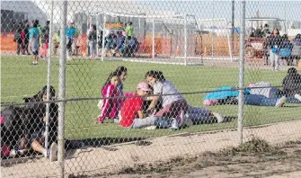  ??  ?? Migrant teens sit inside the camp in Tornillo, Texas, near the Mexican border. It was set up by the Trump administra­tion as a temporary shelter for up to 360 migrant children. Less than six months later, more than 2,000 Central American teens are inside the highly guarded detention camp, which looks set to become a permanent facility.