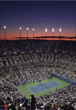  ?? Amy Sancetta / Associated Press ?? The sun sets over the skyline of New York and Arthur Ashe Stadium during the opening night of the U.S. Open in 2008. The men’s profession­al tennis tour is surveying players on LGBTQ issues. ATP CEO Massimo Calvelli tells The Associated Press it is part of a “broader initiative” to create “an environmen­t for players and staff that is inclusive, that is diverse and that is very safe and welcoming.”