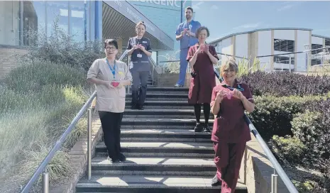  ??  ?? Sunderland Royal Hospital staff holding knitted hearts.