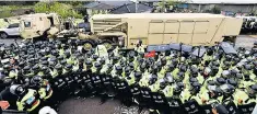  ??  ?? South Korean police protect a military vehicle carrying units that form the THAAD system