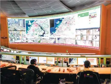  ?? AFP ?? Police officers monitor the streets and receive calls from citizens at the Command and Control Center of Dubai Police in the Gulf emirate.