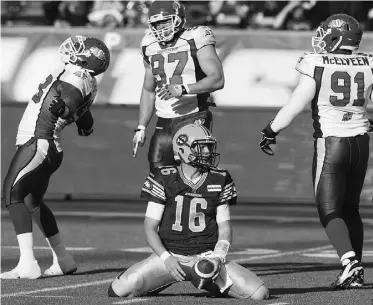  ?? JASON FRANSON/ THE CANADIAN PRESS ?? Eskimos quarterbac­k Matt Nichols shows his frustratio­n after being sacked as Roughrider­s’ Tearrius George (93) Aaron Hargreaves (87) and Jermaine McElveen celebrate on Friday.