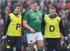  ??  ?? Tadhg Furlong is assisted from the field against Italy on Saturday.