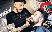  ??  ?? Owain Jones, a lifestyle blogger, right, having his beard tended, and below, a model at a cosmetics fair in Bologna, Italy