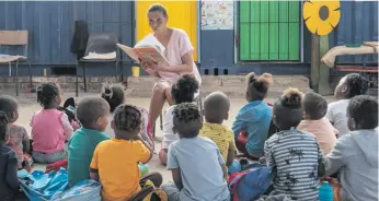  ?? ?? Beaulah Wehr, the principal of the Bambino crèche in Prince Albert, reads to children. The crèche takes care of 50 children but Wehr says that many parents cannot afford to pay the fees of R150 a month, leaving teachers without salaries. Photos: Brenton Geach