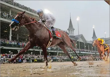  ?? MORRY GASH/AP PHOTO ?? Mike Smith rides Justify to victory during the 144th running of the Kentucky Derby on Saturday at Churchill Downs.
